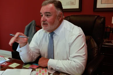 Lawyer joel hamner meets with a client to review a food delivery accident exhibit featuring gps data.