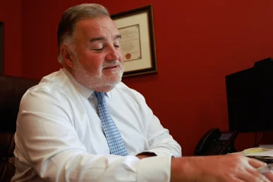 Lawyer joel hamner meets with a client to review an organ damage injury exhibit with medical imaging evidence.