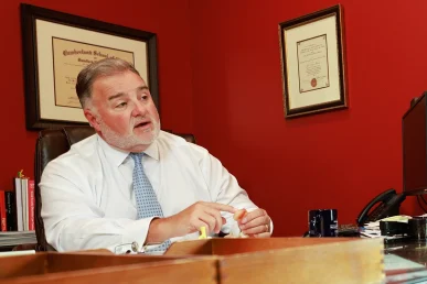 Lawyer joel hamner presents a t bone accident exhibit to a client, showing intersection signal evidence.