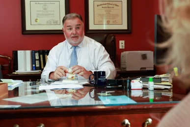 Lawyer joel hamner presents a day care accident exhibit to a client, highlighting childcare safety concerns.