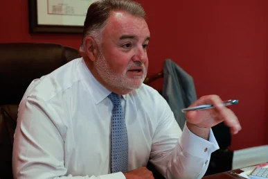 Lawyer joel hamner presents a landlord liability exhibit to a client, highlighting property defects.