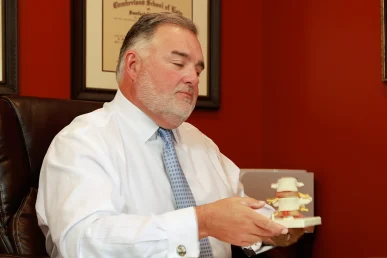 Lawyer joel hamner presents an uber eats accident exhibit to a client, covering delivery route data.