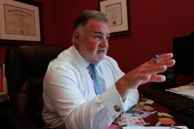Lawyer joel hamner reviews a bicycle accident exhibit with a client, focusing on road conditions and driver negligence.