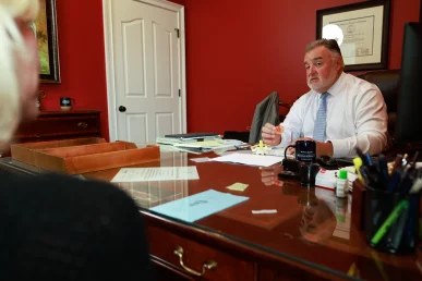 Lawyer joel hamner reviews a drunk driving accident exhibit with a client, focusing on police test evidence.