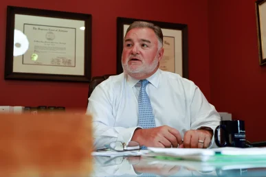 Lawyer joel hamner reviews a fender bender exhibit with a client, highlighting minor collision details.