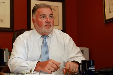 Lawyer joel hamner reviews an insurance bad faith exhibit with a client, detailing claim denial evidence.