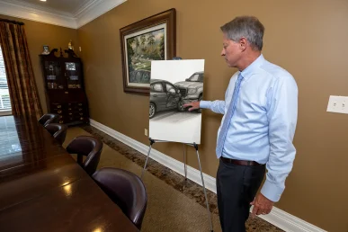 Lawyer tom mccutcheon discusses a passenger injury exhibit with seatbelt and impact data.