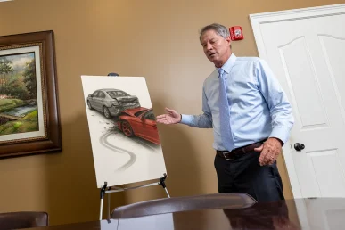 Lawyer tom mccutcheon discusses a speeding accident exhibit featuring impact evidence.