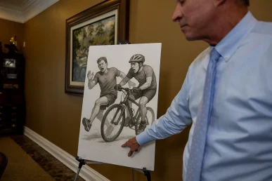 Lawyer tom mccutcheon examines a jogger accident exhibit showing driver visibility and pedestrian crossing data.
