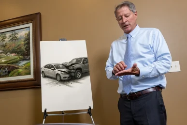 Lawyer tom mccutcheon explains an uninsured driver accident exhibit detailing insurance coverage gaps.