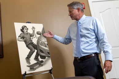 Lawyer tom mccutcheon reviews a skateboard accident exhibit with pavement condition photos.