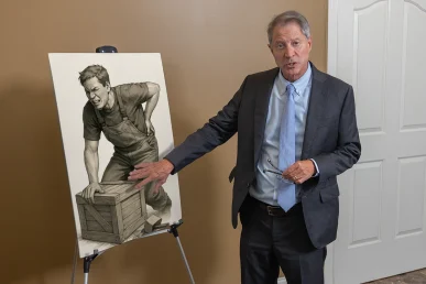 Lawyer tom mccutcheon reviews a strains and contusions exhibit featuring injury photos and treatment records.