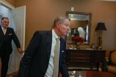 Lawyers tom mccutcheon and joel hamner examine flight safety reports while planning an aviation crash lawsuit for an injured passenger.