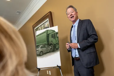Personal injury attorney tom mccutcheon consults with a client about a garbage truck accident claim.
