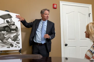 Personal injury attorney tom mccutcheon consults with a client about a golf cart accident case.