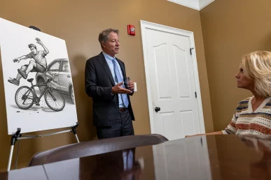 Personal injury attorney tom mccutcheon meets with a client to discuss a bone fracture injury claim.
