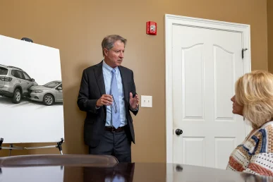 Personal injury attorney tom mccutcheon meets with a client to discuss a minor fender bender case.