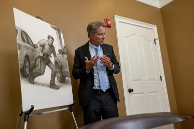 Personal injury attorney tom mccutcheon meets with a client to discuss a runaway vehicle accident case.