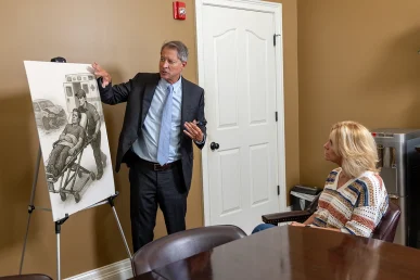 Personal injury attorney tom mccutcheon meets with a client to discuss an organ damage injury case.