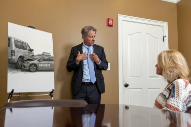 Personal injury attorney tom mccutcheon meets with a client to review a grubhub accident case.