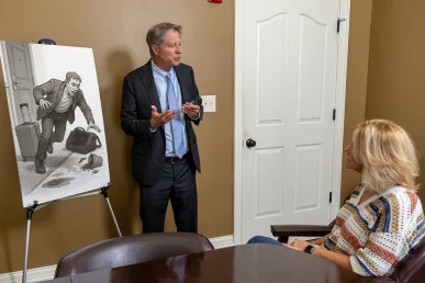 Personal injury attorney tom mccutcheon meets with a client to review a hotel accident case.