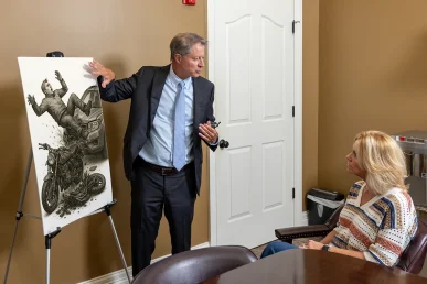 Personal injury attorney tom mccutcheon reviews a paralysis injury case with a client.