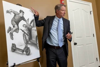 Personal injury attorney tom mccutcheon reviews a scooter accident case with a client.