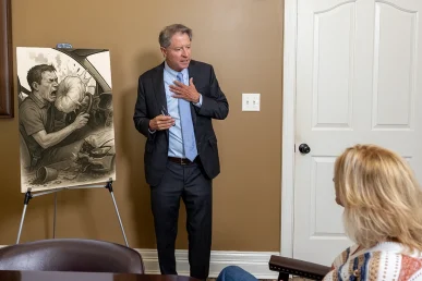 Personal injury attorney tom mccutcheon talks with a client about a defective airbag case.
