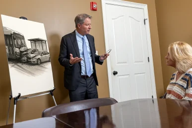 Personal injury attorney tom mccutcheon talks with a client about a potential bus stop accident claim.