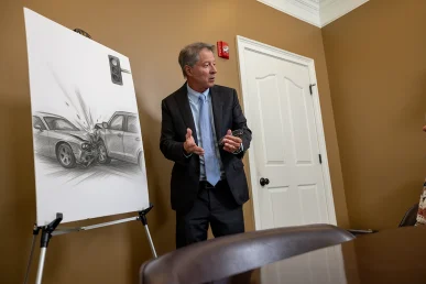 Personal injury attorney tom mccutcheon talks with a client about a reckless driving accident lawsuit.