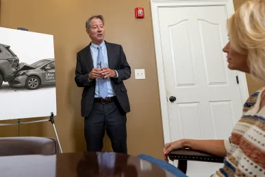 Personal injury attorney tom mccutcheon talks with a client about an uber eats accident case.