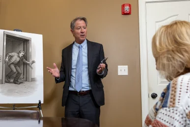 Personal injury attorney tom mccutcheon talks with a client about an elevator accident case.
