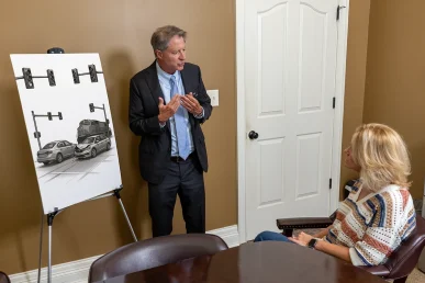 Personal injury attorney tom mccutcheon talks with a client about an intersection accident case.