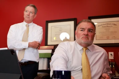 Tom mccutcheon and joel hamner consult with a client about legal options for a child injury case.