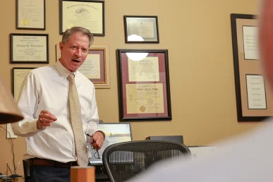 Tom mccutcheon and joel hamner meet in tom’s office to review an electrocution accident claim.