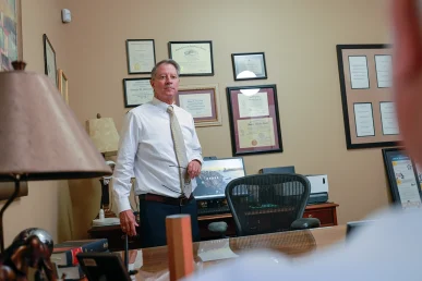 Tom mccutcheon and joel hamner meet in tom’s office with a client to review a bus accident claim.