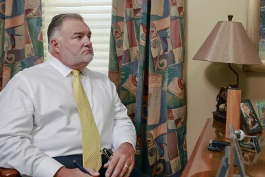 Tom mccutcheon and joel hamner meet with a client in tom’s office to review a dirt bike accident case.
