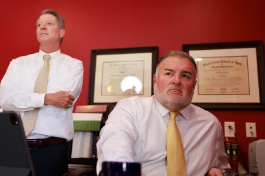 Tom mccutcheon and joel hamner meet with a client to analyze a workplace crane accident case.