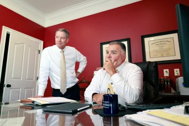 Tom mccutcheon and joel hamner meet with a client to discuss a potential lyft rideshare accident case.