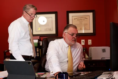Tom mccutcheon and joel hamner meet with a client to discuss evidence in a brake failure accident case.