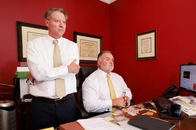 Tom mccutcheon and joel hamner meet with a client to discuss workplace or accident related hearing loss.