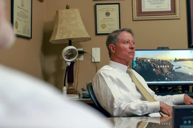 Tom mccutcheon and joel hamner meet with a client to review a t bone accident case.