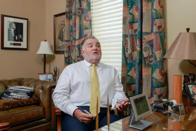 Tom mccutcheon and joel hamner meet with a client to review a defective medical device lawsuit.
