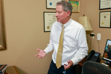 Tom mccutcheon and joel hamner meet with a client to review a farm accident lawsuit.