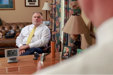 Tom mccutcheon and joel hamner meet with a client to review a motorcycle accident claim.