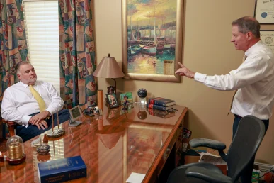 Tom mccutcheon and joel hamner meet with a client to review a passenger injury case.