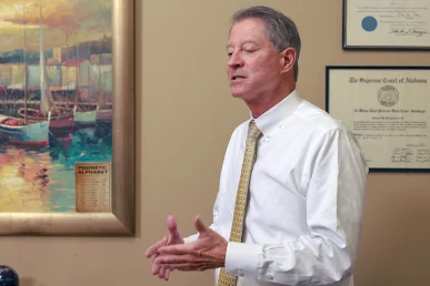 Tom mccutcheon and joel hamner meet with a client to review a rear end crash claim.