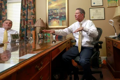 Tom mccutcheon and joel hamner meet with a client to review a workplace accident case.
