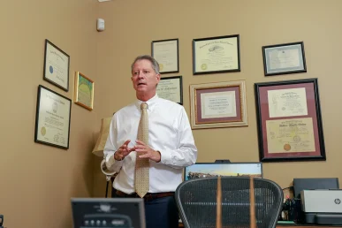 Tom mccutcheon and joel hamner meet with a client to review an intersection accident case.