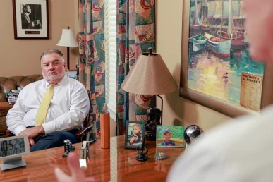 Tom mccutcheon and joel hamner meet with a client to review an organ damage injury case.